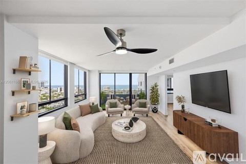 A modern living room with a large window overlooking the city.