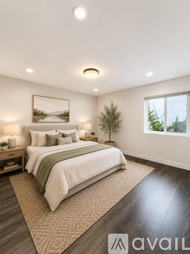 A bedroom with a large bed and a painting on the wall.