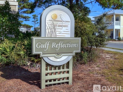 A sign that says Gulf Reflections in front of a building.