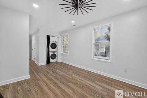 A room with a wooden floor and a ceiling fan.