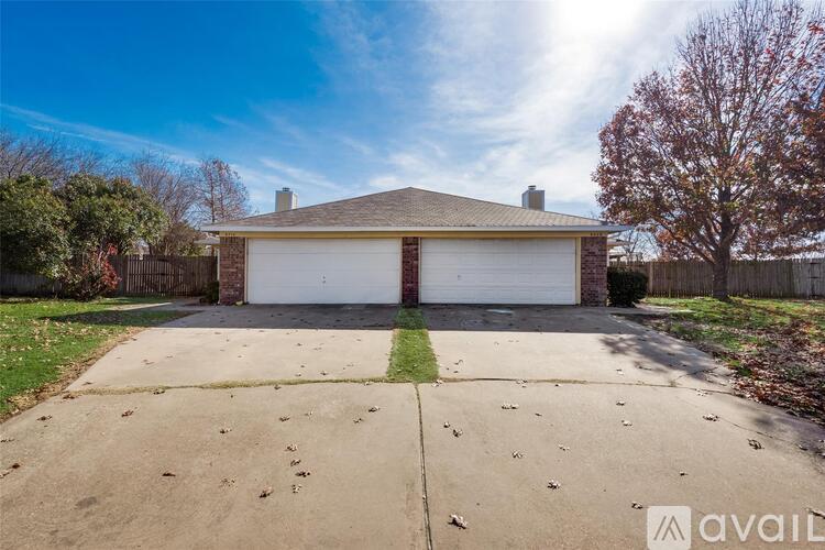 A two-car garage with a brick chimney is situated in a residential area.