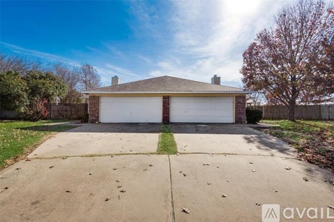 A two-car garage with a brick chimney is situated in a residential area.