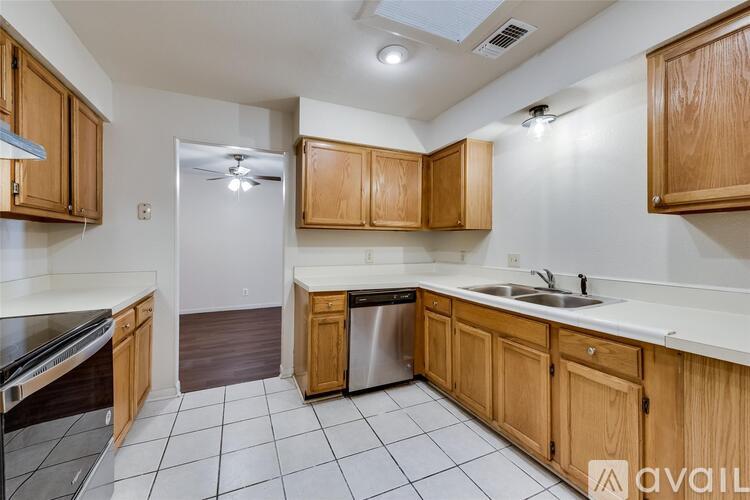 A kitchen with wooden cabinets and a white countertop.
