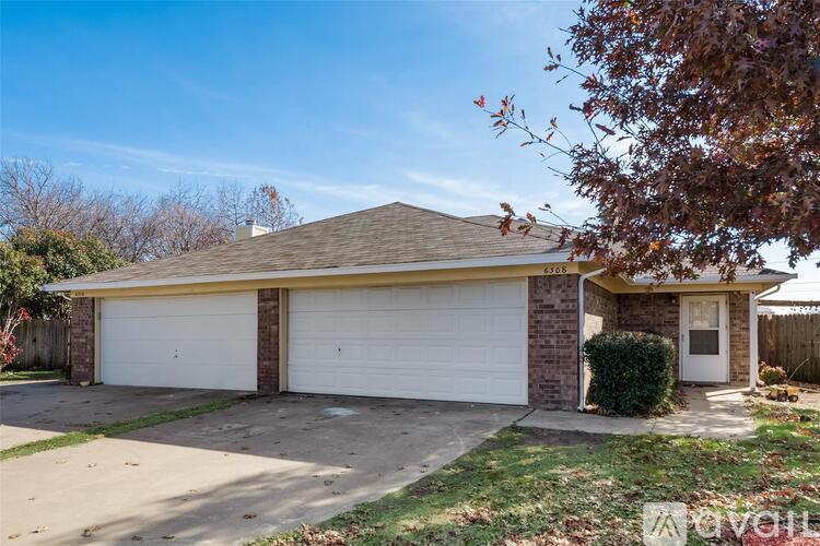 A two-car garage with a brick facade and a gabled roof.