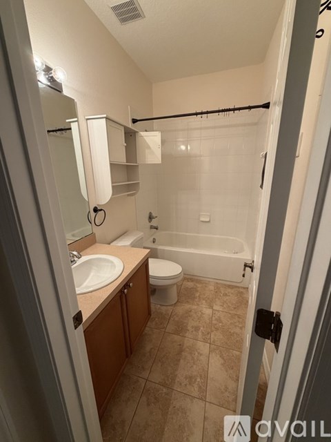 A bathroom with a sink, toilet and bathtub.