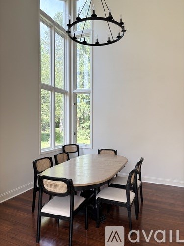 A dining room with a round table and chairs.