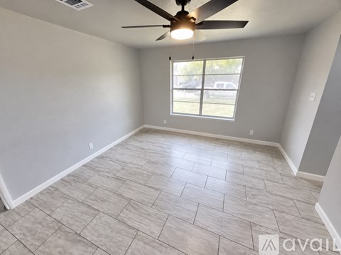 A room with a ceiling fan and a window.