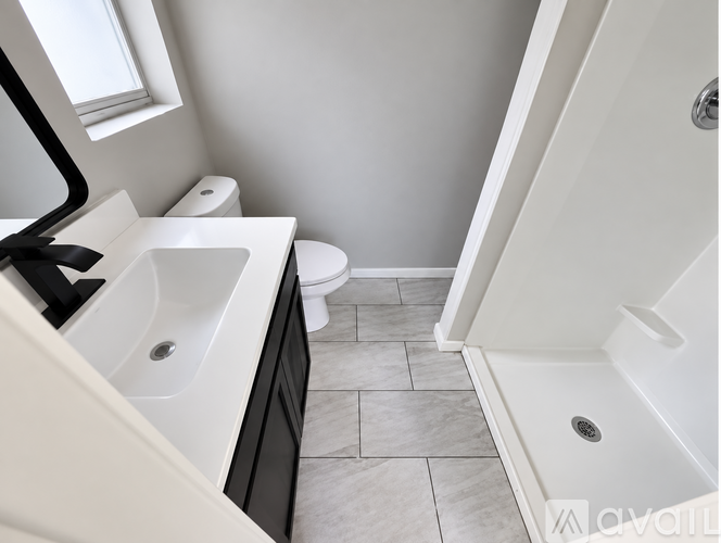 A bathroom with a toilet, sink, and bathtub.