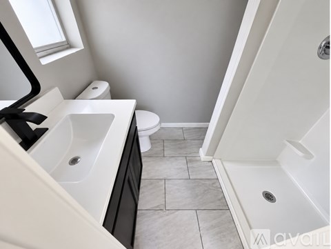 A bathroom with a toilet, sink, and bathtub.