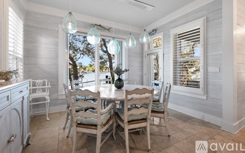 A dining room with a table set for four.