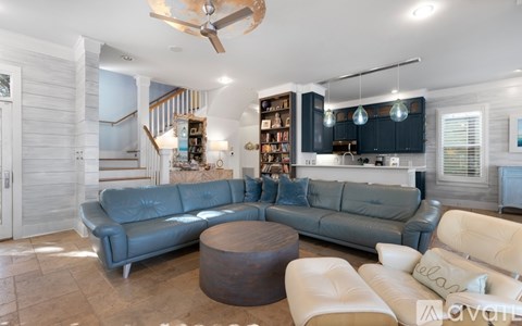 A living room with a grey couch and a wooden coffee table.