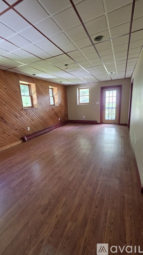 A room with wooden floors and a white ceiling.