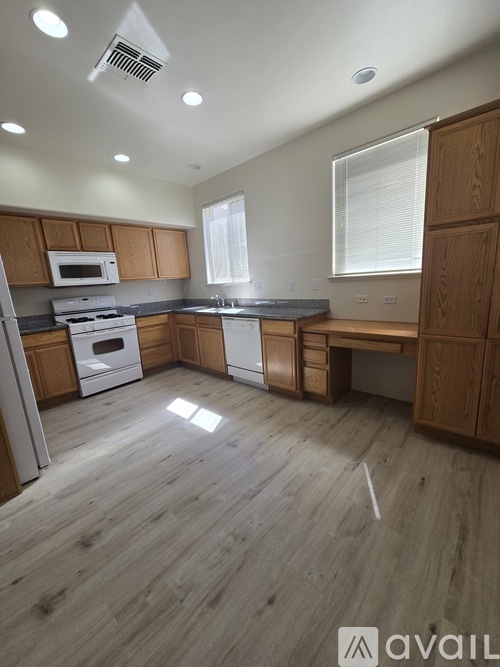 A kitchen with wooden cabinets and a white oven.
