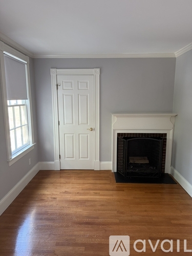 A room with a fireplace and a door.