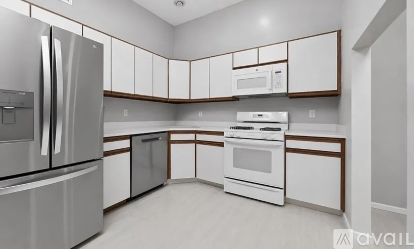 A modern kitchen with white appliances and cabinets.