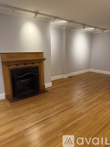 A room with a fireplace and wooden floors.