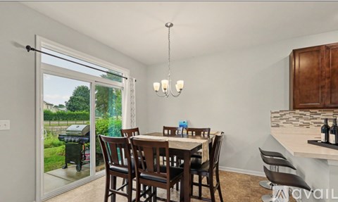 A dining room with a table set for four.