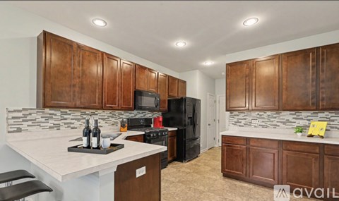 A kitchen with brown cabinets and a white countertop.