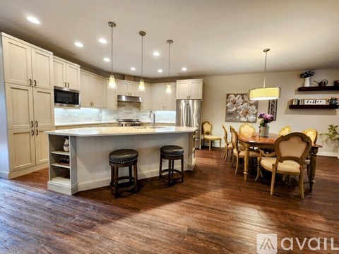 A kitchen with a bar area and a dining table set up.