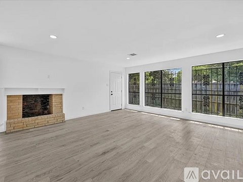 A spacious living room with a fireplace and sliding glass doors.