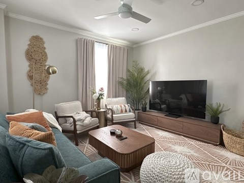 A living room with a blue couch and a television.