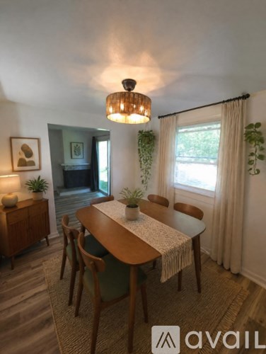 A dining room with a wooden table and chairs.