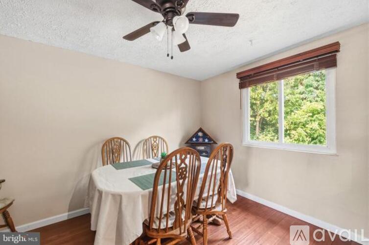 A dining room with a table set for four.