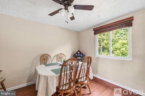 A dining room with a table set for four.