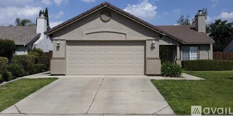A house with a garage door and a driveway.