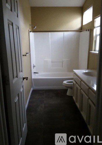 A bathroom with a toilet, sink, and bathtub.