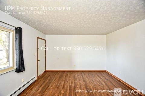 A room with wood flooring and a text that says "HPM Property Management".