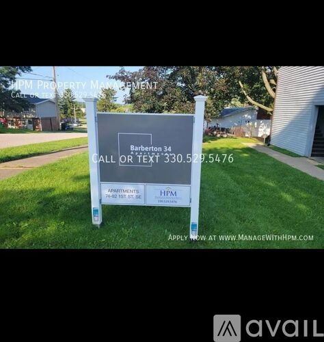 A sign for HPM Property Management is displayed in a grassy area.