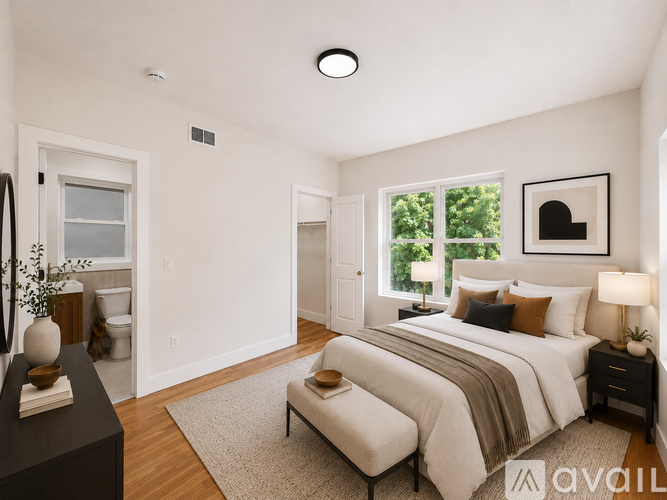 A well-lit bedroom with a large bed and a window.