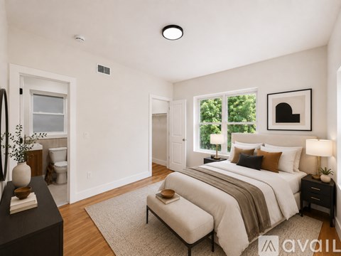 A well-lit bedroom with a large bed and a window.