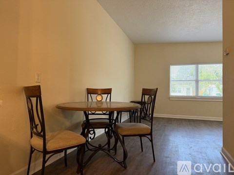 A dining room with a table and chairs.
