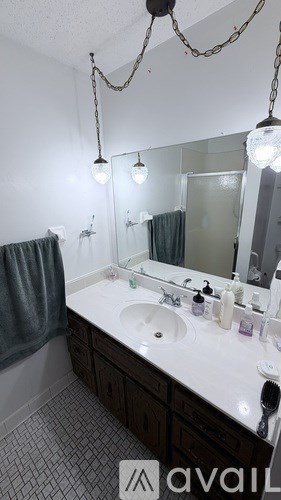 A bathroom with a white sink and a mirror.