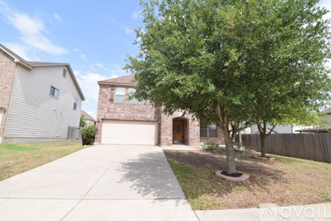 A house with a tree in front of it.