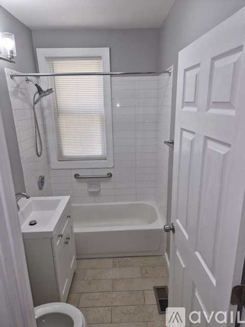 A bathroom with a toilet, sink, and bathtub.