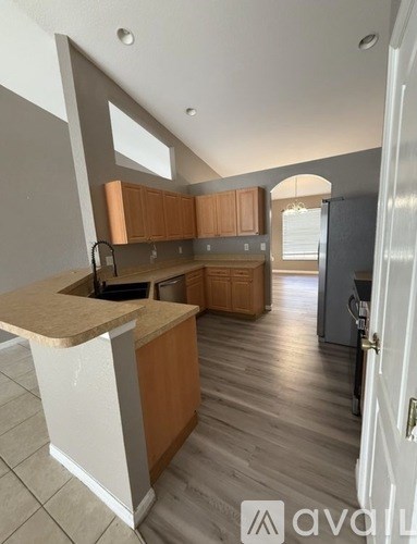 A kitchen with wooden cabinets and a counter.
