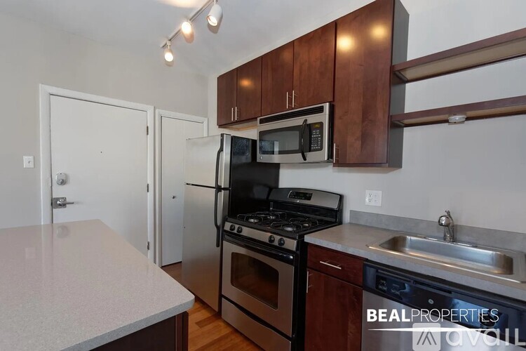 A kitchen with a stove top oven and microwave above it.