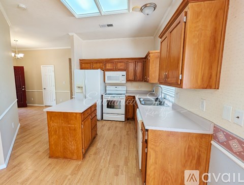 A kitchen with wooden cabinets and a white countertop.