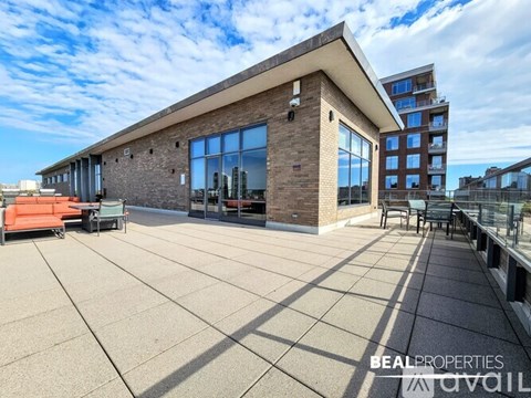 A modern building with a flat roof and large windows is showcased in the image.