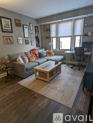 A living room with a grey couch and a wooden coffee table.