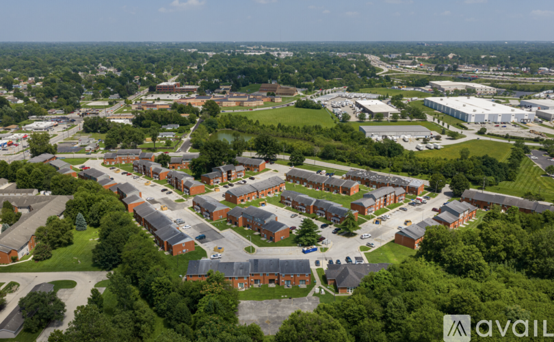 An aerial view of a large building complex surrounded by trees.