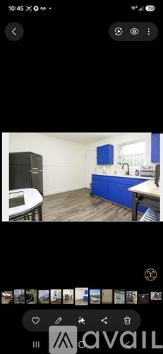 A kitchen with blue cabinets and a white countertop.