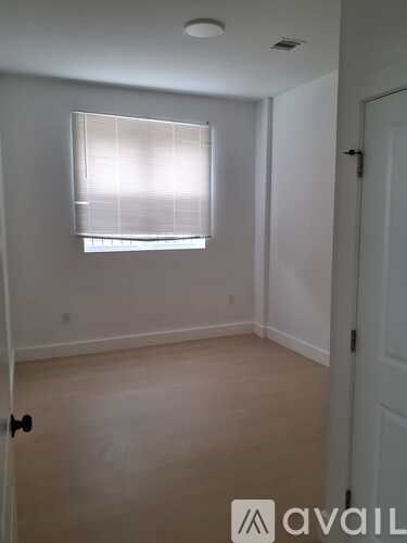 A room with a window and a door.