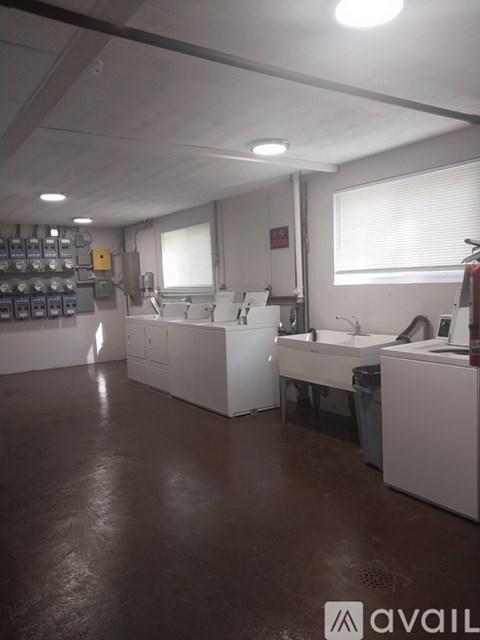 A clean, well-lit industrial workspace with white cabinets and equipment.