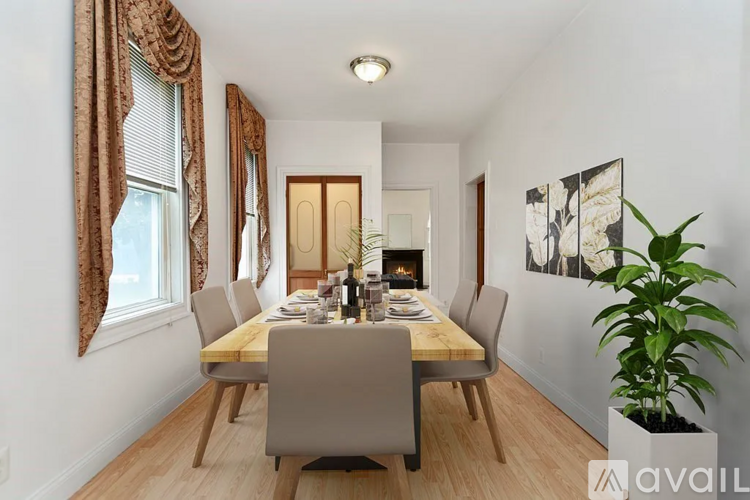 A dining room with a long table and chairs.