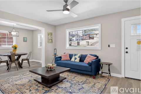 A living room with a blue couch and a coffee table.