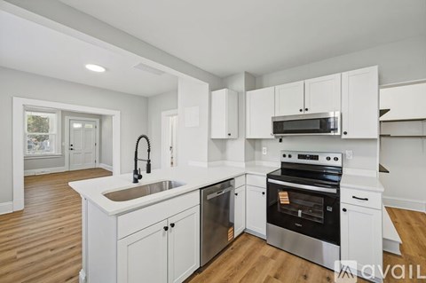 A kitchen with white cabinets and stainless steel appliances.